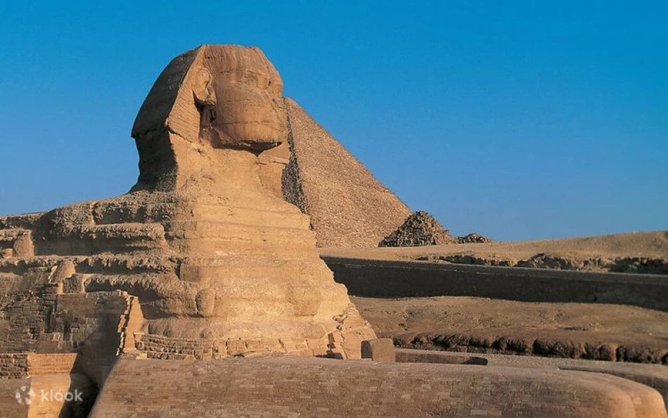 statue of a reclining sphinx, a mythical creature with the head of a human and the body of a lion.