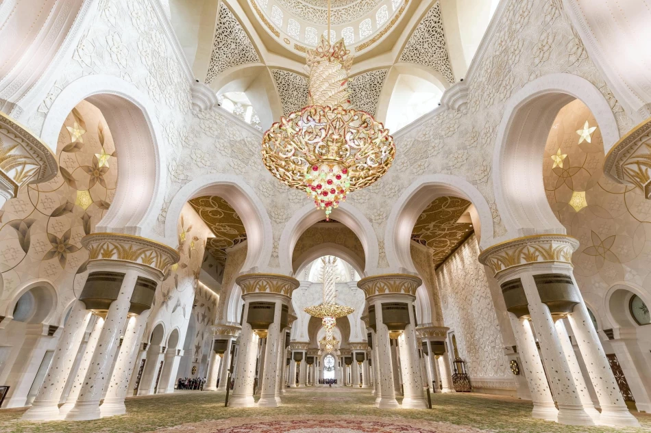Inside Sheikh Zayed Grand Mosque with chandeliers and carpet