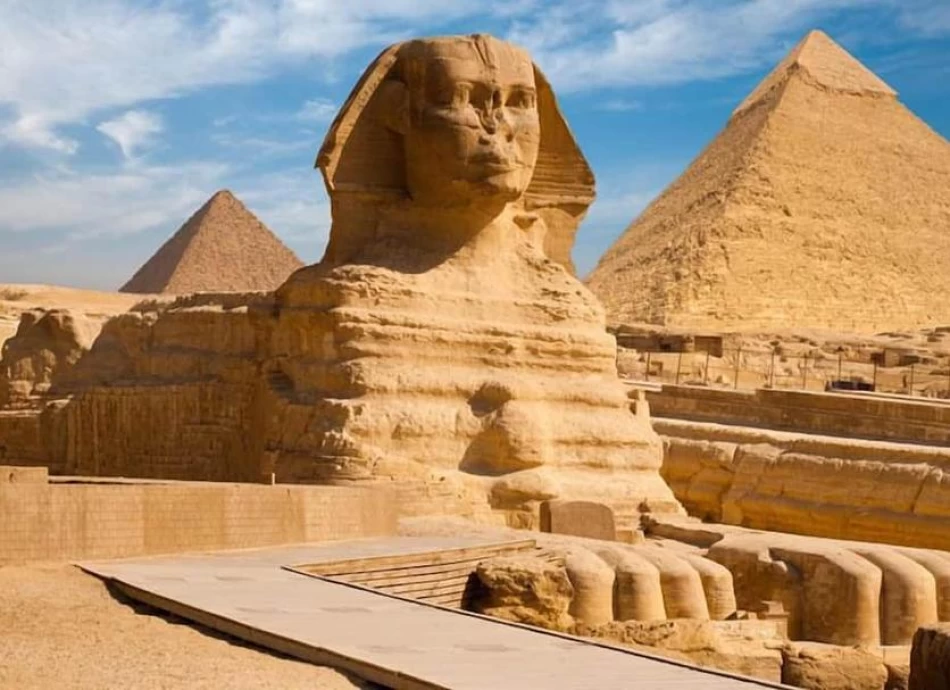 The Sphinx statue guarding the Pyramids of Giza desert plateau