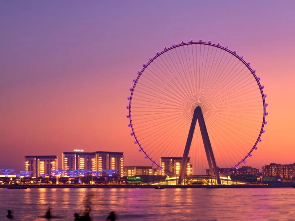 Dubai Eye Ferris wheel against a vibrant pink sunset sky