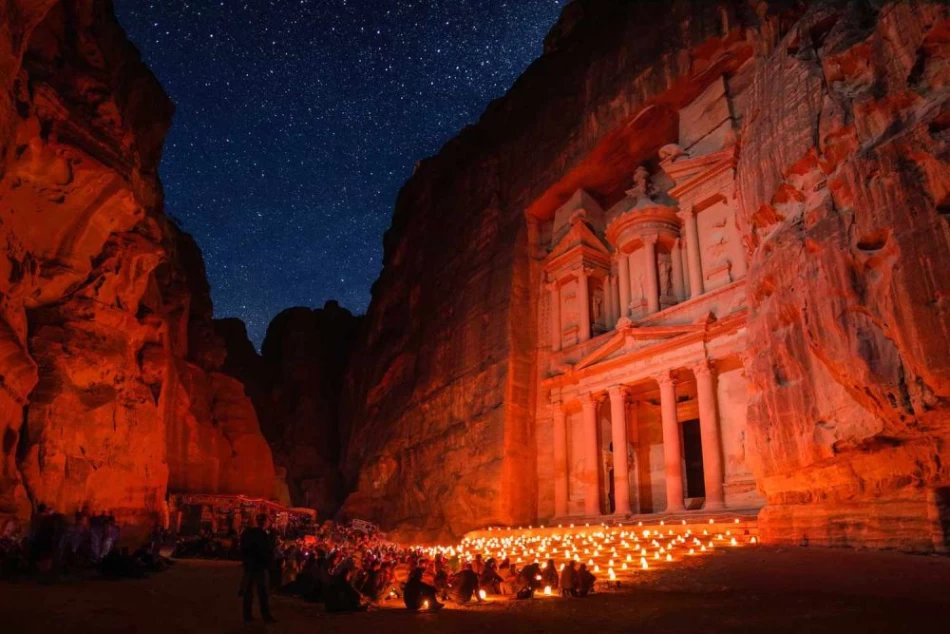 Petra lit up at night with glowing lights, highlighting the rock cut architecture