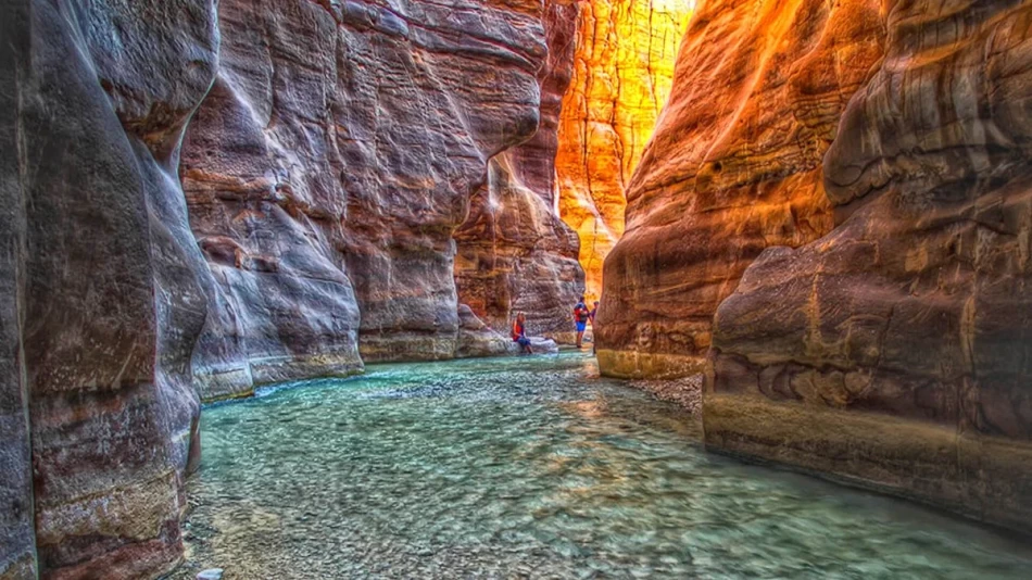 Scenic view of Wadi Mujib canyon in Jordan with dramatic cliffs and flowing water through the gorge