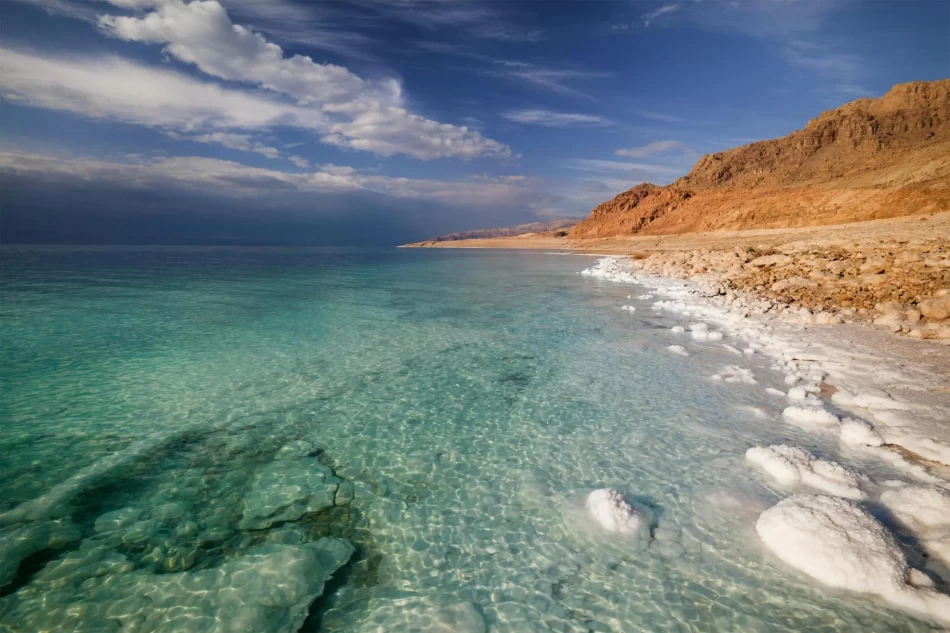 Crystal salt formations and turquoise waters of the Dead Sea along the Jordanian shoreline
