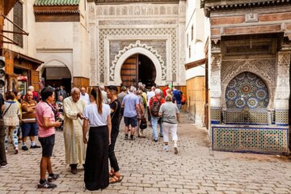 Tourist admiring intricate architecture and courtyards in a Moroccan palace