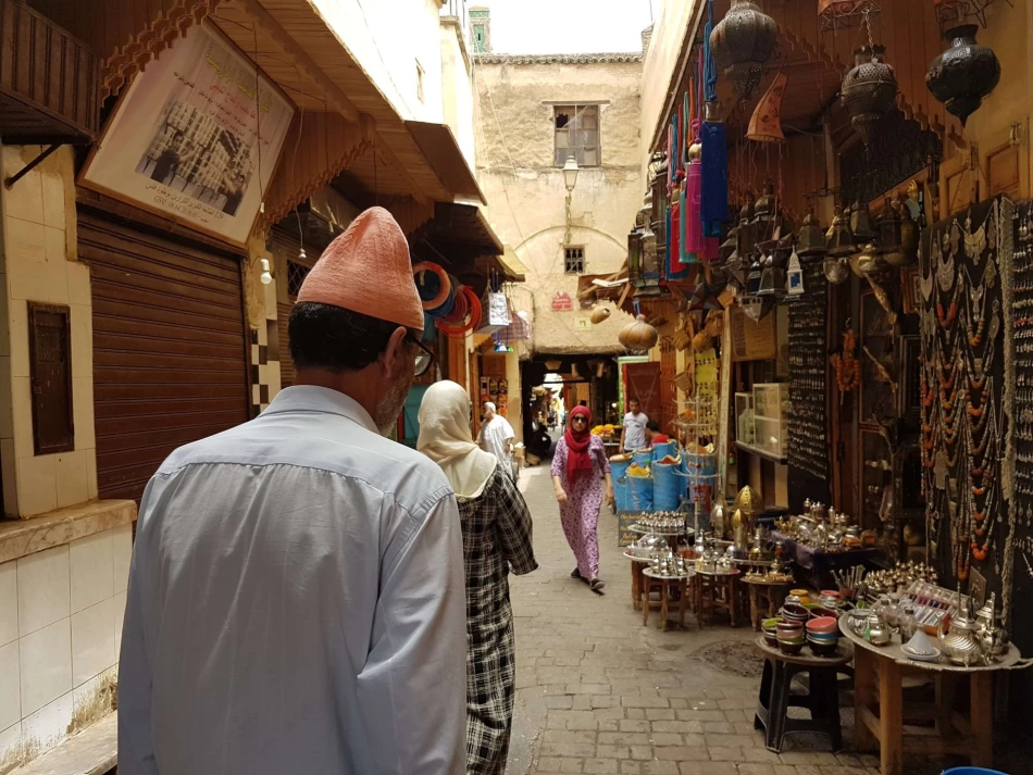 Shoppers walking through the narrow alleys of the historic Fez market