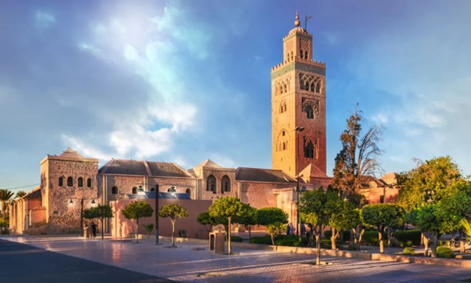 View of the Koutoubia Mosque in Marrakech with its tall historic minaret surrounded by palm trees