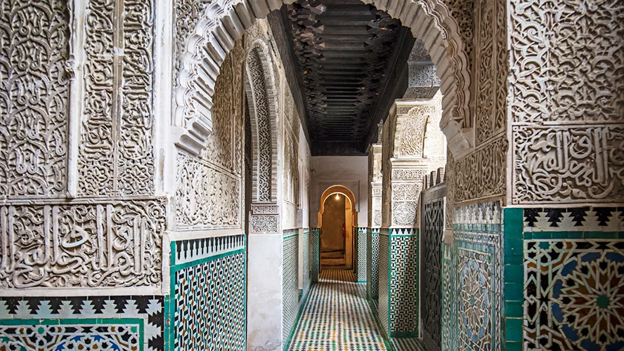 Interior of Bou Inania Madrasa in Fez, Morocco, showcasing intricate zellige tilework