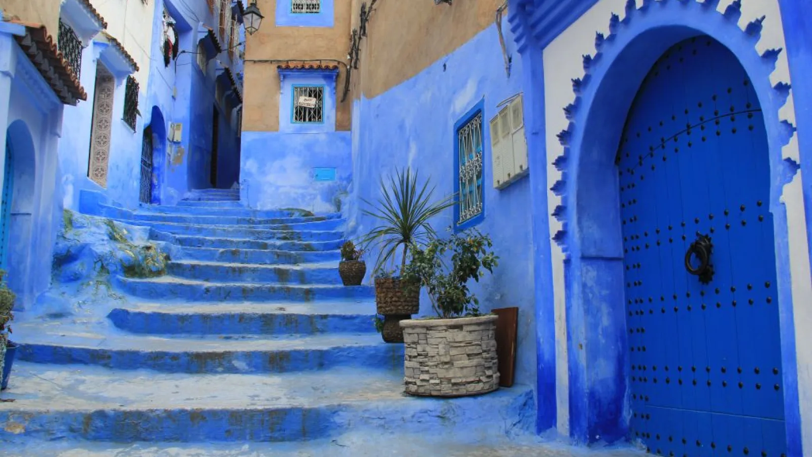 Vibrant blue streets of Chefchaouen lined with colorful traditional Moroccan doors