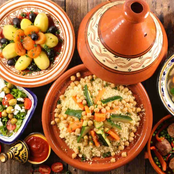 A colorful table filled with traditional Moroccan dishes tagines and couscous
