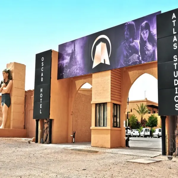 Main entrance of Atlas Studios Morocco in Ouarzazate with iconic movie sets in the background