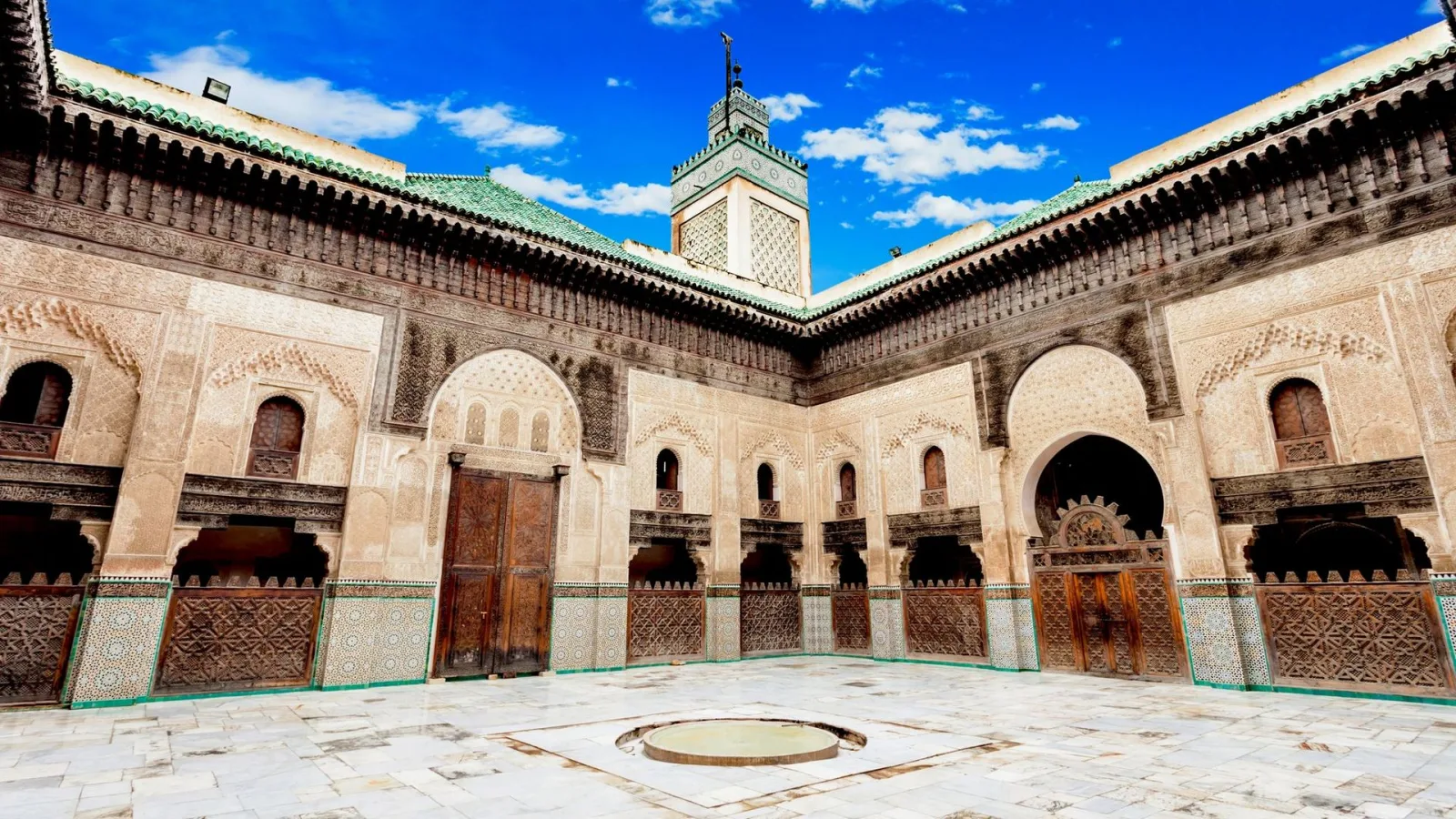 Interior courtyard of Bou Inania Madrasa featuring Moroccan architecture and decorative details