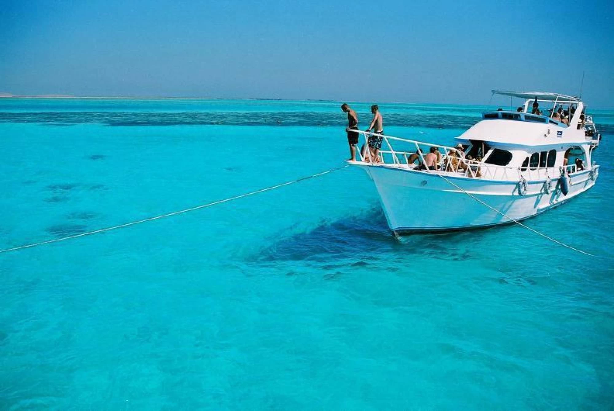 White yacht sailing on calm blue waters near Giftun Island in Hurghada