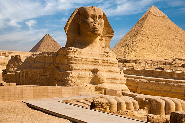 Scenic view of the Great Pyramids of Giza and the Sphinx with a clear blue sky in the background