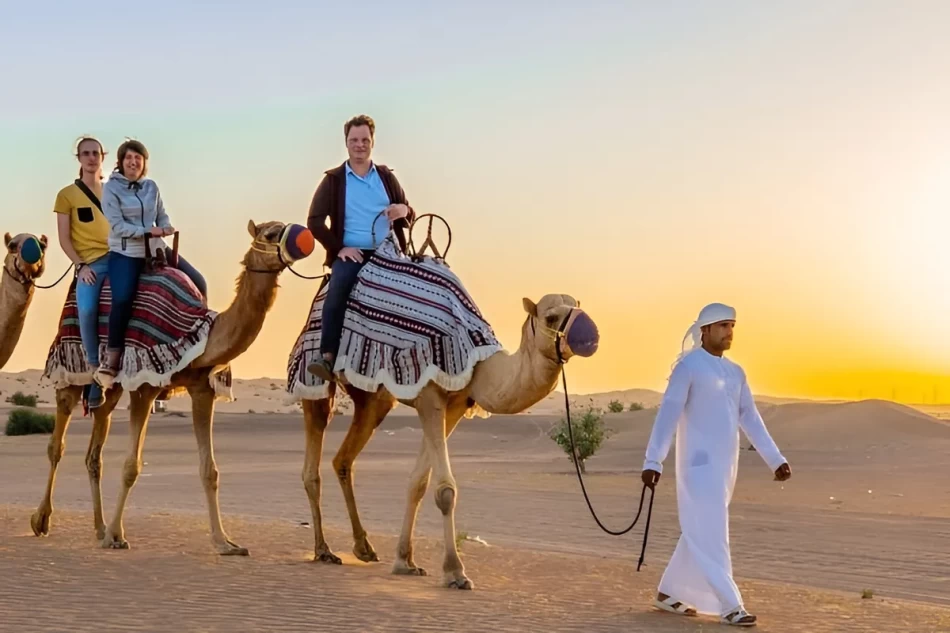 Tourist enjoying a camel ride across the golden dunes of the Sinai Desert
